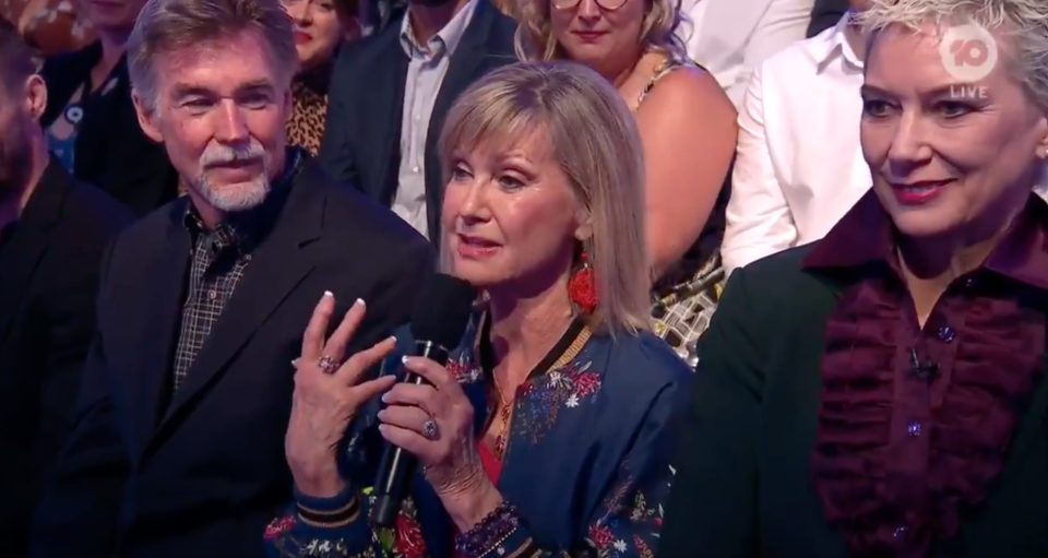 Olivia Newton-John speaks into the microphone on Dancing With The Stars