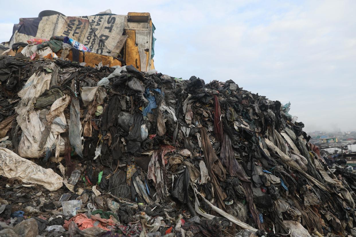 A general view of discarded clothes at a dump site at Old Fadama in Accra, Ghana, on Nov. 15, 2023. Ghana became the world's largest importer of used clothing in 2021, according to the Observatory of Economic Complexity data site.