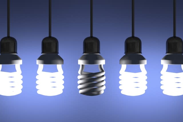 Switched off fluorescent light bulb hanging among glowing ones on blue textured background