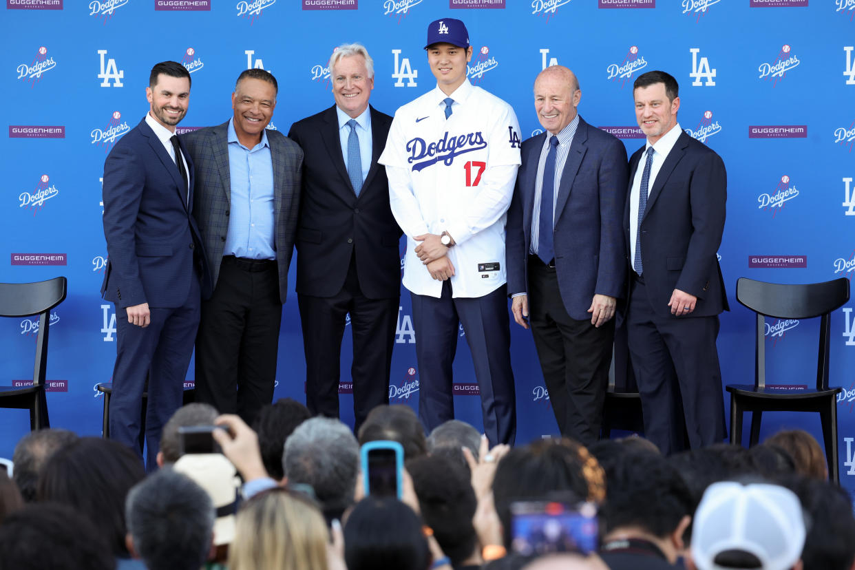 LOS ANGELES, CA - DECEMBER 14: Dodgers announcer Joe Davis, from left, stands for a photo with manager Dave Roberts, owner Mark Walter, Shohei Ohtani, president Stan Kasten, and president baseball operations Andrew Friedman as the Los Angeles Dodgers introduce Ohtani as the newest member of the team during a press conference at Dodger Stadium in Los Angeles Thursday, Dec. 14, 2023.  The Dodgers signed Ohtani to a 10-year $700 million contract on a blockbuster free agency signing. (Wally Skalij / Los Angeles Times via Getty Images)