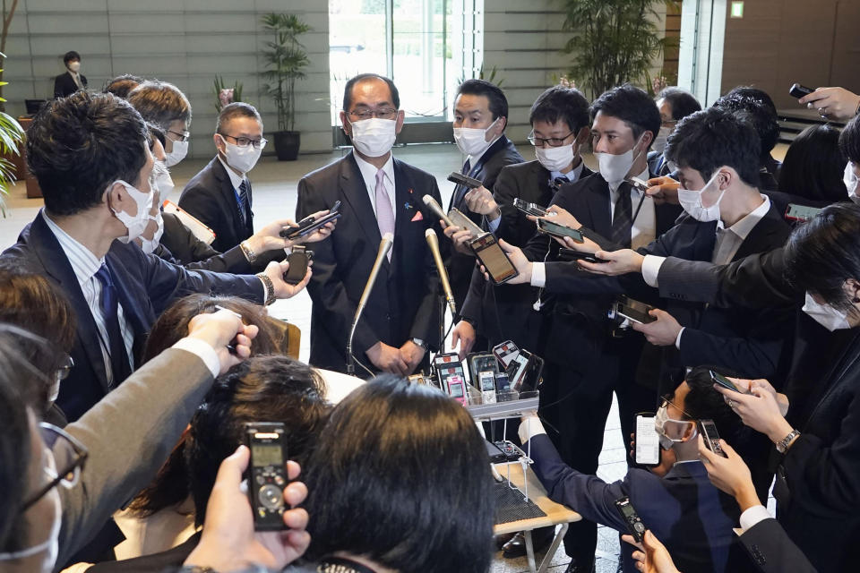 Takeaki Matsumoto, newly appointed internal affairs minister, is surrounded by reporters after Matsumoto met Japanese Prime Minister Fumio Kishida at the prime minister's office in Tokyo, Japan, Monday, Nov 21, 2022. Minoru Terada, the internal affairs minister in Japanese Prime Minister Fumio Kishida's government, was forced into resigning over funding problems on Sunday, in a blow to the scandal-prone Cabinet that has already lost two ministers in one month. (Kyodo News via AP)