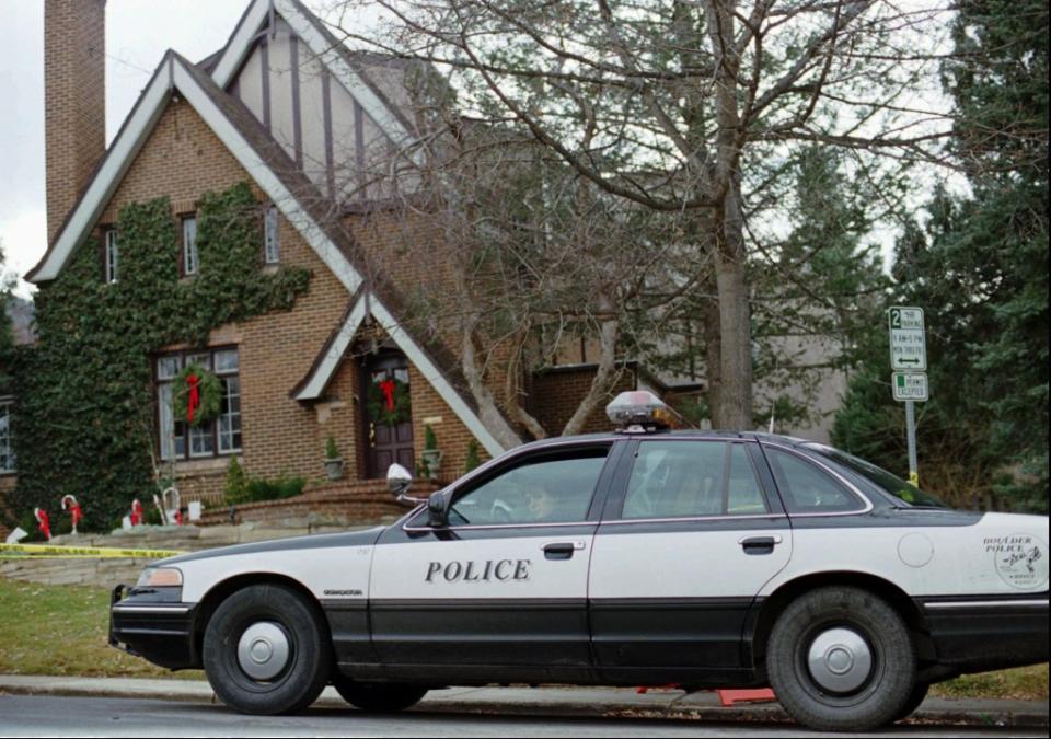 A police officer sits in her cruiser on Friday, Jan. 3, 1997, outside the Ramsey home. AP