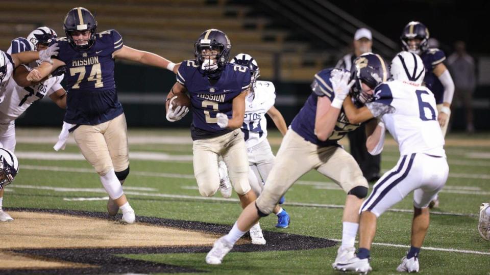 Mission Prep’s offensive line opens up running room for Chase Untal, who scored on this run with blocking help from Case Christiansen, left, and Gabe Rodriguez. MIssion Prep beat Aptos 18-15 in a home football game at Cal Poly’s Spanos Stadium on Sept. 8, 2023. David Middlecamp/dmiddlecamp@thetribunenews.com