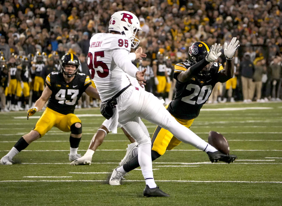 Iowa defensive back Deavin Hilson (20) nearly blocks a punt by Rutgers punter Flynn Appleby (95) during the second half of an NCAA college football game, Saturday, Nov. 11, 2023, in Iowa City, Iowa. (AP Photo/Bryon Houlgrave)