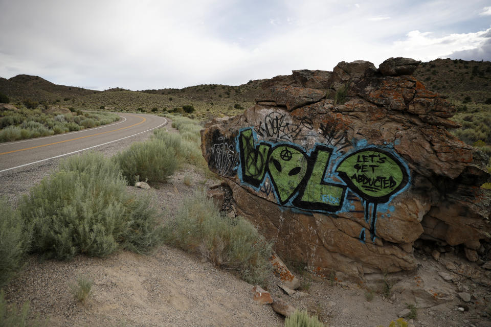 In this July 22, 2019 photo, alien themed graffiti adorns a rock along the Extraterrestrial Highway, near Rachel, Nev., the closest town to Area 51. The U.S. Air Force has warned people against participating in an internet joke suggesting a large crowd of people "storm Area 51," the top-secret Cold War test site in the Nevada desert. (AP Photo/John Locher)