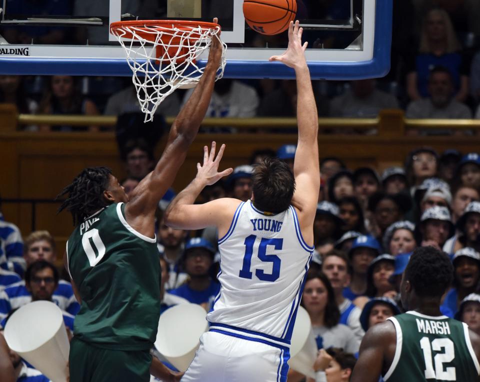 Jacksonville University center Omar Payne (o) tries to block a shot by Duke's Ryan Young (15) during last week's game at Cameron Indoor Stadium.