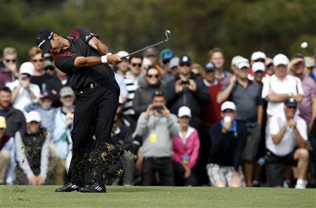 Australia's Jason Day plays his approach shot to the 18th green on his way to winning the World Cup of Golf at The Royal Melbourne Golf Club in Melbourne November 24, 2013. REUTERS/Brandon Malone