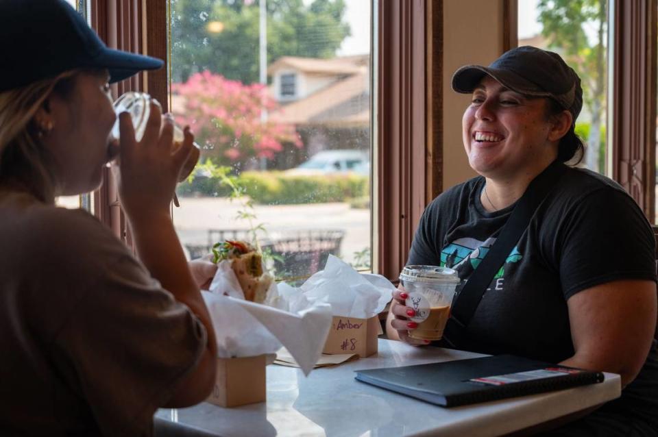 South sacramento resident Mai Thao and Galt resident Amber Garcia eat at Tule Coffeehouse in Elk Grove on Saturday, July 20, 2024. “It was the perfect little spot to get some work done,” Garcia said after the two played a game of pickleball nearby.