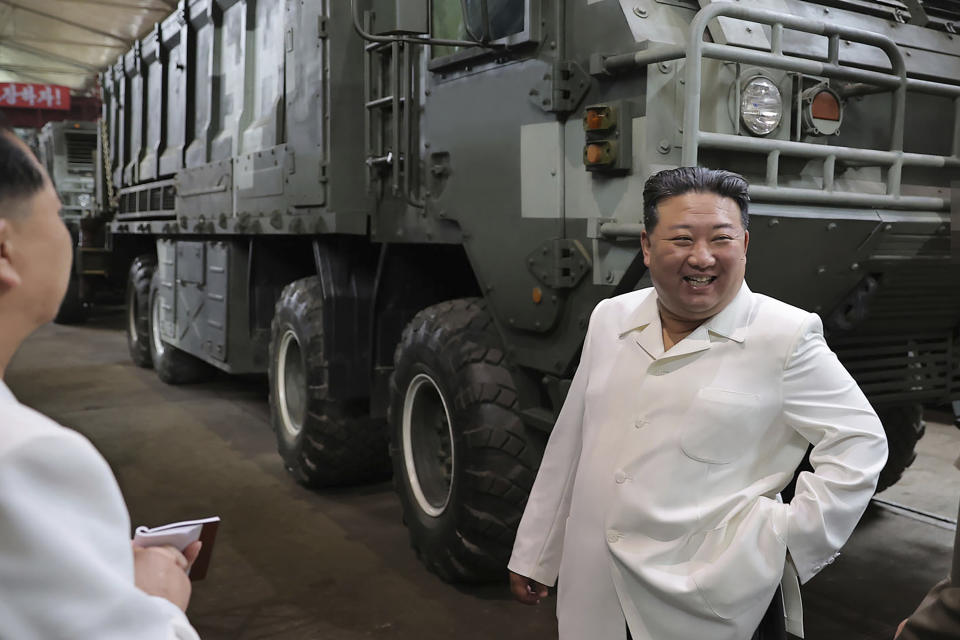 In this undated photo provided on Monday, Aug. 14, 2023, by the North Korean government, North Korean leader Kim Jong Un, right, smiles in front of a military vehicle, during his Aug. 11-12 visit to a military factory in North Korea. Independent journalists were not given access to cover the event depicted in this image distributed by the North Korean government. The content of this image is as provided and cannot be independently verified. Korean language watermark on image as provided by source reads: "KCNA" which is the abbreviation for Korean Central News Agency. (Korean Central News Agency/Korea News Service via AP)