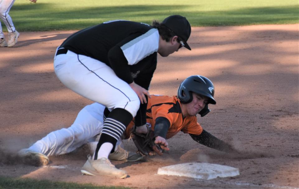 Thomas Service (left), playing third base for Frankfort-Schuyler after reaching his pitch limit in the seventh inning Thursday, tags out Cooperstown Hawkeye Paul Crowell trying to steal the base.