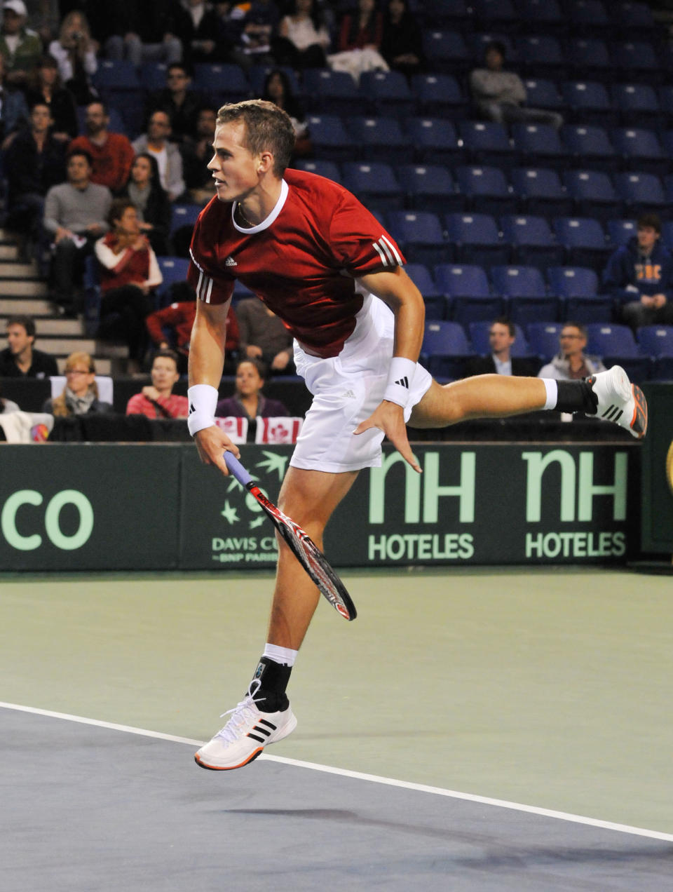 Vasek Pospisil of Canada serves to Jo-Wilfried Tsonga of France during the Davis Cup tennis action on February 10, 2012 at the Doug Mitchell Thunderbird Sports Centre, University of British Columbia, Vancouver, British Colombia, Canada. AFP PHOTO / Don MACKINNON (Photo credit should read Don MacKinnon/AFP/Getty Images)