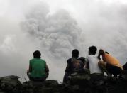 <p>Filipino villagers sit along the slopes of rumbling Mayon Volcano as it spews ash in Legaspi city, Albay province, Philippines, Jan. 16,2018. (Photo: Francis R. Malasig/EPA-EFE/REX/Shutterstock) </p>