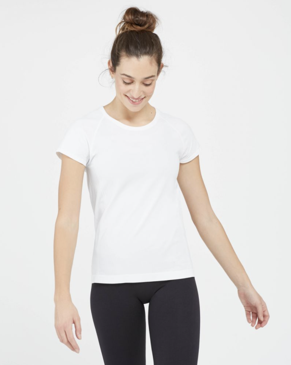 brunette model wearing black leggings and white Look at Me Now Seamless Tee in White 