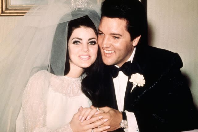 <p>Bettmann/Getty</p> Priscilla and Elvis Presley after their wedding in May 1967