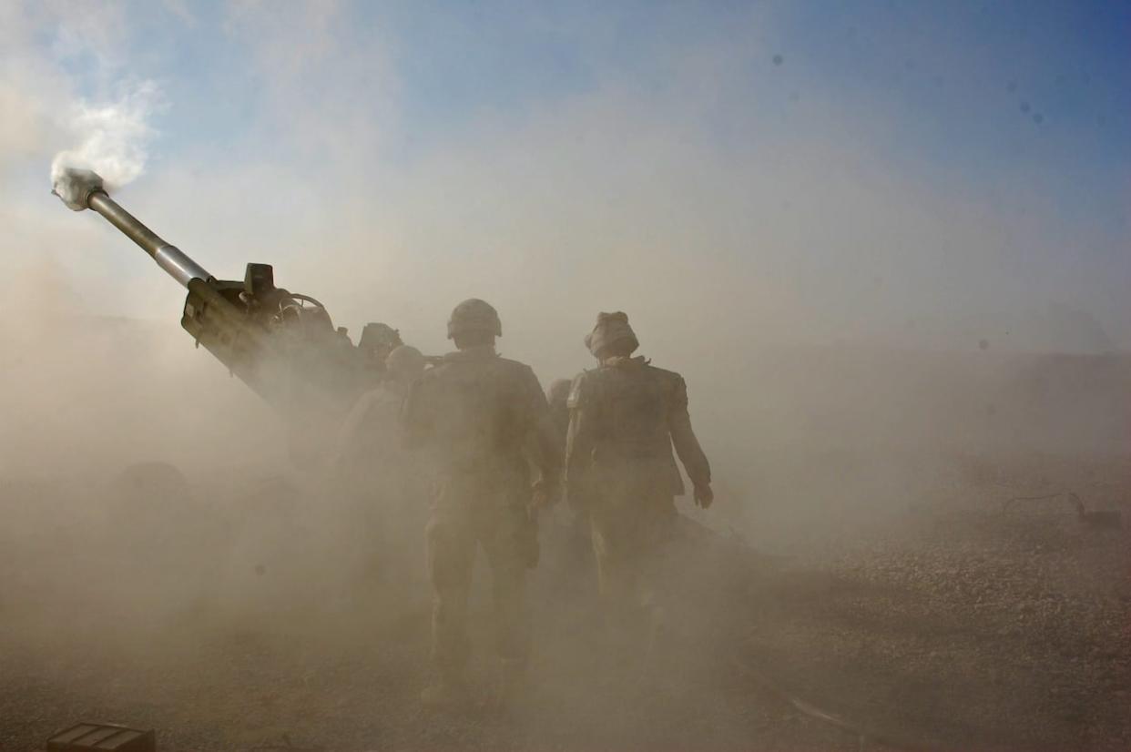 Gunners from D Battery, 2nd Regiment Royal Canadian Horse Artillery, prepare to reload during a fire support mission in Shojah, Afghanistan in December, 2010. (Murray Brewster/The Canadian Press - image credit)