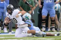 Tulane linebacker Dorian Williams (2) sacks Central Florida quarterback John Rhys Plumlee (10) during the first half of the American Athletic Conference championship NCAA college football game in New Orleans, Saturday, Dec. 3, 2022. (AP Photo/Matthew Hinton)