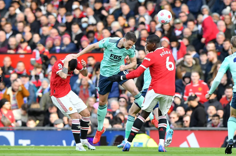 MANCHESTER, ENGLAND - APRIL 02: Jonny Evans of Leicester City with Bruno Fernandes of Manchester United and Paul Pogba of Manchester United during the Premier League match between Manchester United and Leicester City at Old Trafford on April 2, 2022 in Manchester, United Kingdom. (Photo by Plumb Images/Leicester City FC via Getty Images)