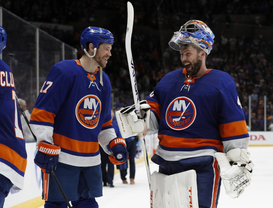 New York Islanders left wing Matt Martin (17) and goaltender Semyon Varlamov (40) celebrate after the team's 3-2 win over the Tampa Bay Lightning in Game 4 of an NHL hockey Stanley Cup semifinal, Saturday, June 19, 2021, in Uniondale, N.Y. (AP Photo/Jim McIsaac)