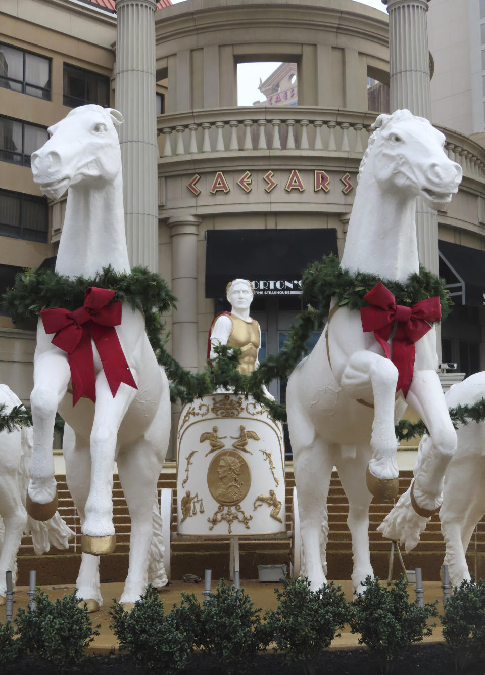 Holiday decorations adorn the sculptures outside Caesars casino in Atlantic City, N.J. on Dec. 28, 2023. Atlantic City faces challenges in the new year including a potential smoking ban in its nine casinos, and their quest to return to pre-pandemic business levels. (AP Photo/Wayne Parry)