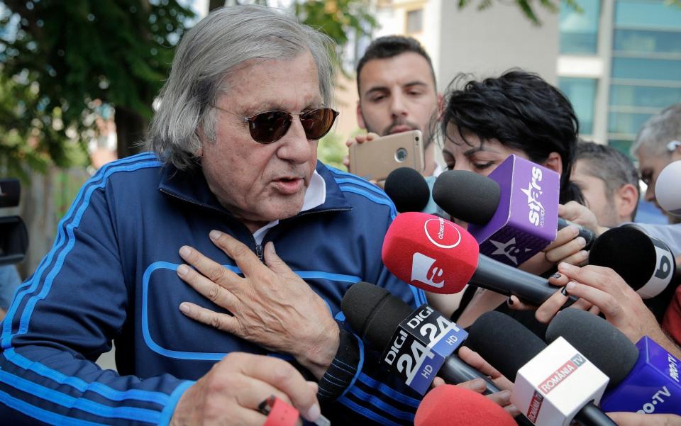 Ilie Nastase is questioned by reporters on Friday  - AP