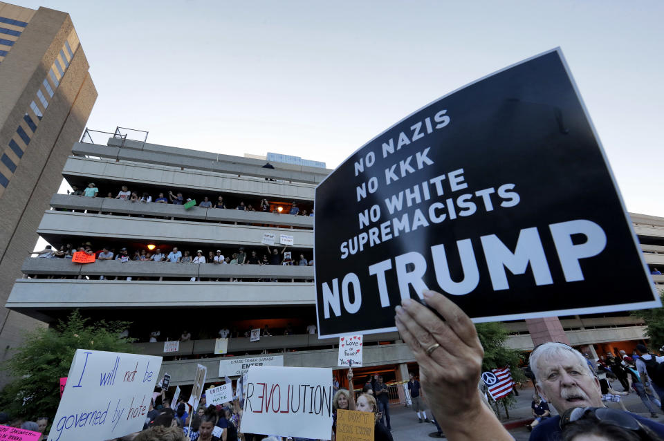 <p>People protest outside the Phoenix Convention Center, Tuesday, Aug. 22, 2017, in Phoenix. Protests were held against President Trump as he hosted a rally inside the convention center. (AP Photo/Matt York) </p>