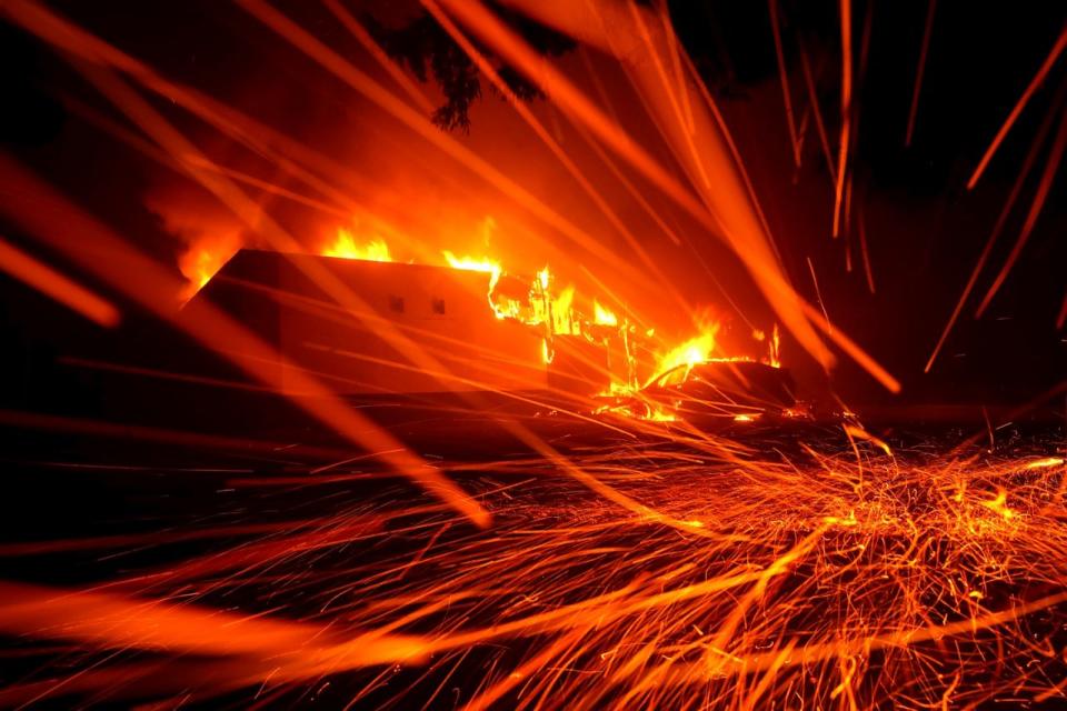 <p>Embers blow in the wind as a Camp Fire burns a KFC restaurant on Nov. 8, 2018 in Paradise, Calif.<br>(Photo from Justin Sullivan, Getty Images) </p>