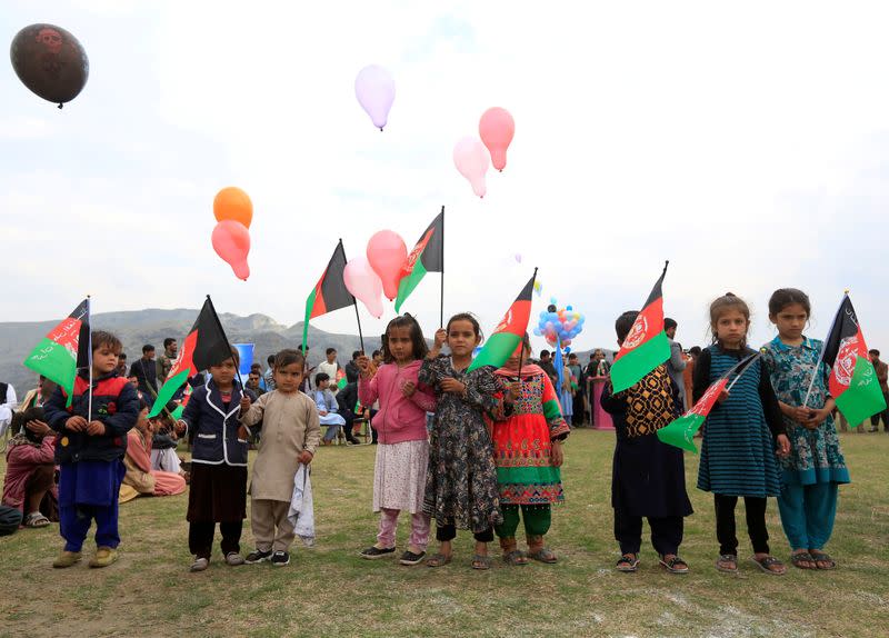 Afghan children celebrate in anticipation of the U.S-Taliban agreement to allow a U.S. troop reduction and a permanent ceasefire, in Jalalabad