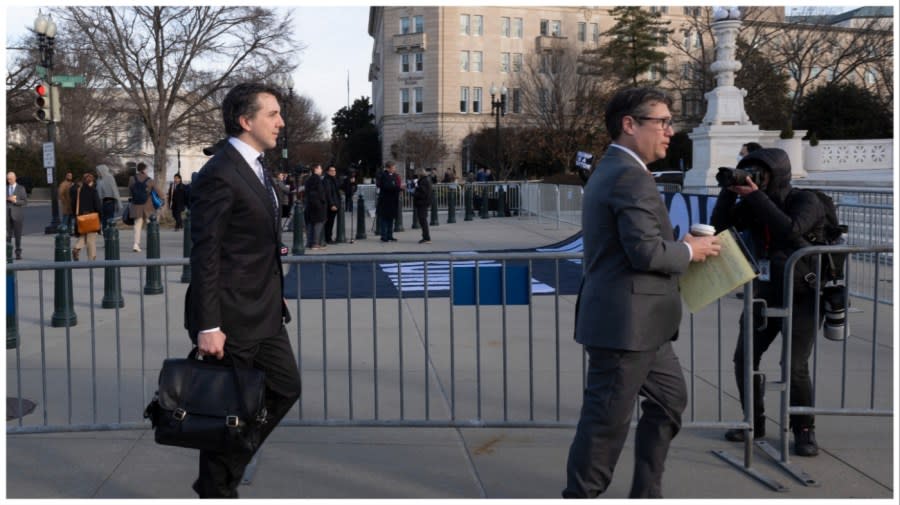 <em>Jason Murray (left), the lead attorney for the Colorado voters in the lawsuit, walks past anti-Trump demonstrators outside the US Supreme Court on February 8, 2024.</em>