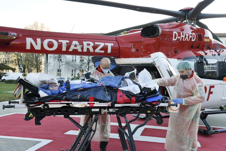 From the Corona intensive care unit of the Paul Gerhard Stift Evangelical Hospital, a pregnant woman suffering from Covid 19 is taken to the DRF helicopter by Air Rescue emergency in Wittenberg, Germany, Friday, Dec. 3, 2021 For medical reasons, the woman is transferred to the prenatal centre at Halle University Hospital. (Waltraud Grubitzsch/dpa via AP)