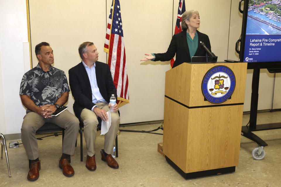 Hawaii Attorney General Anne Lopez, right, introduces Fire Safety Research Institute (FSRI) members Derek Alkonis, left, and Steve Kerber during a press conference on the Maui Wildfire Phase One Report findings on Wed, April 17, 2024, in Honolulu. (AP Photo/Marco Garcia)