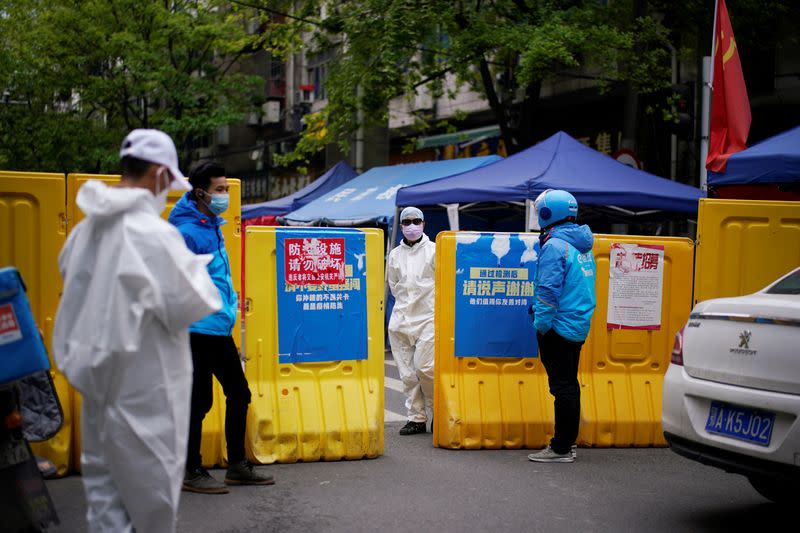 A check point of a community is seen at a residential area blocked by barriers in Wuhan