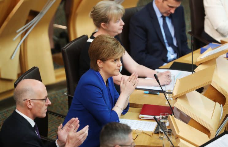 A grim-faced Nicola Sturgeon after her speech in the Scottish Parliament (PA)