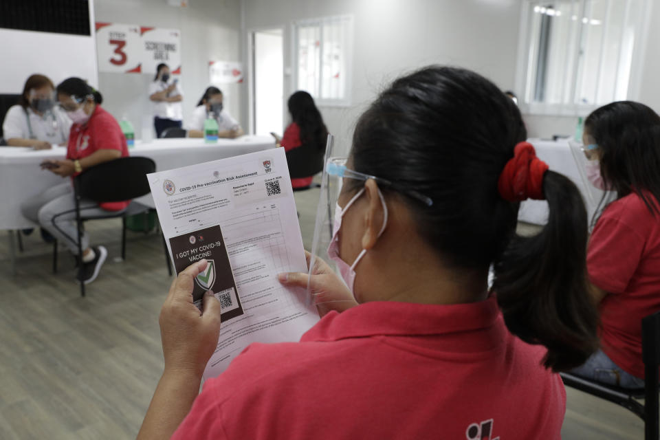 A volunteer waits for her turn during a "COVID-19 Vaccination Dry Run" as they still wait for vaccinations in Taguig, Philippines on Wednesday, Jan. 27, 2021. The Philippine government continues to face criticisms for failing to immediately launch a vaccination program amid a global scramble for COVID-19 vaccines. (AP Photo/Aaron Favila)