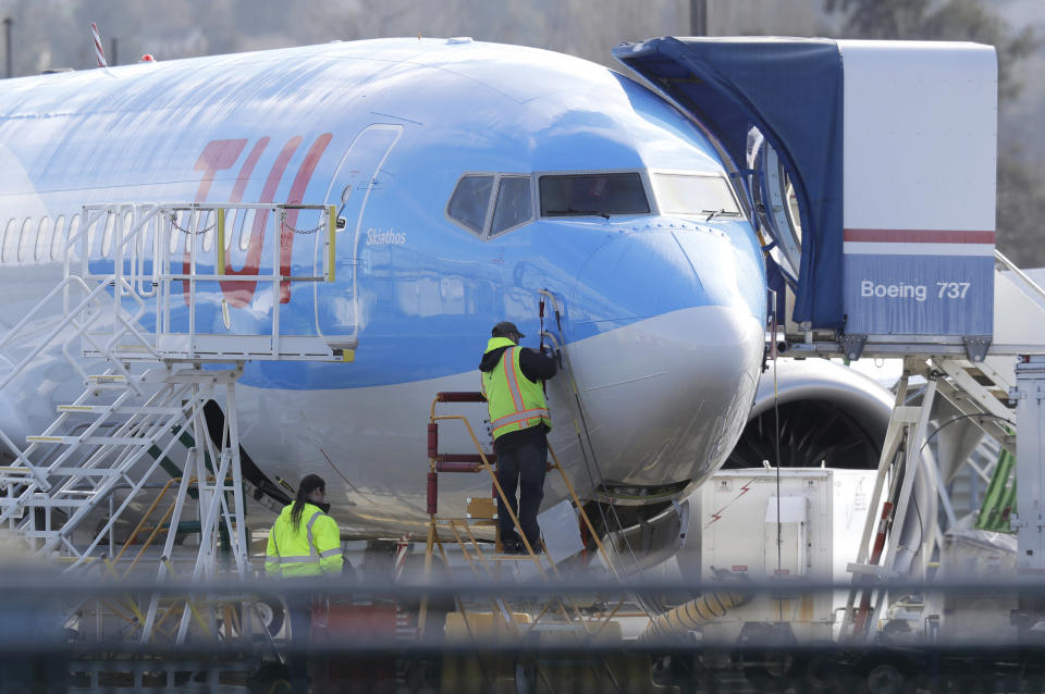 A worker stands on a platform near a Boeing 737 MAX 8 airplane being built for TUI Group at Boeing Co.&#39;s Renton Assembly Plant Wednesday, March 13, 2019, in Renton, Wash. President Donald Trump says the U.S. is issuing an emergency order grounding all Boeing 737 Max 8 and Max 9 aircraft in the wake of a crash of an Ethiopian Airliner. (AP Photo/Ted S. Warren)