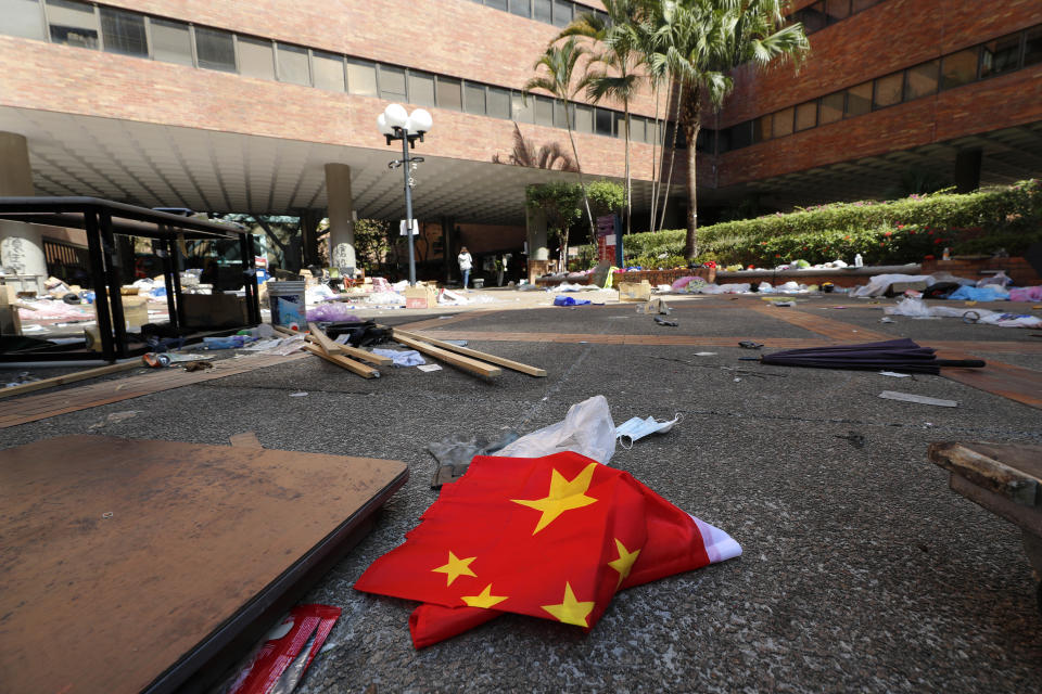 A Chinese flag lies amid debris at Hong Kong Polytechnic University in Hong Kong, Friday, Nov. 29, 2019. Hong Kong police were preparing Friday to reopen access to the university campus after blocking it for 12 days to try to arrest protesters holed up inside. (AP Photo/Vincent Thian)