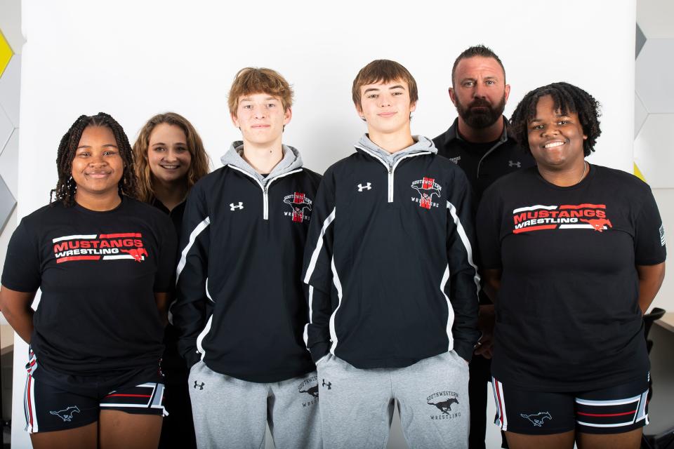 (Front row, from left) South Western wrestlers Davina Crump, Daniel Pierce, Landon Dull and Kayla Henderson pose for a photo with coaches Jennifer Strine and Jeremy Ault during YAIAA winter sports media days Wednesday, November 8, 2023, in York.