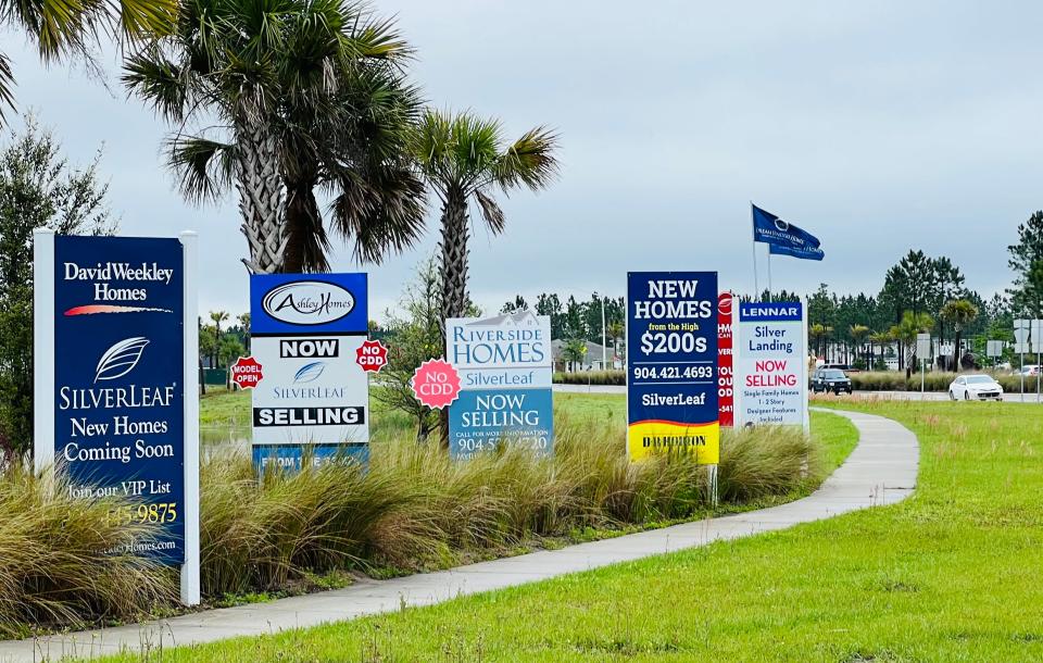 Signs advertise new homes for sale by various builders along SilverLeaf Parkway at Hutson Companies' massive 8,500-acre SilverLeaf community in St. Johns County on Monday, March 13, 2023.