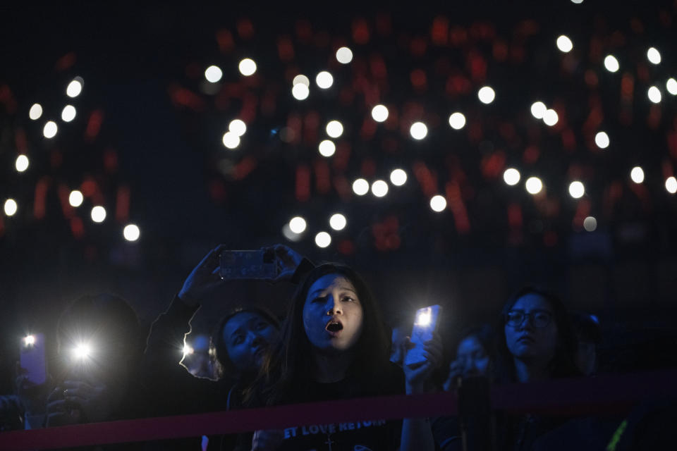 Fans of Chinese rappers including Boss X react during a performance in Chengdu in southwestern China's Sichuan province, Saturday, March 16, 2024. The rapper, who had come up from making music in a run-down apartment in an old residential community in the city, was now playing to a stadium of thousands. (AP Photo/Ng Han Guan)