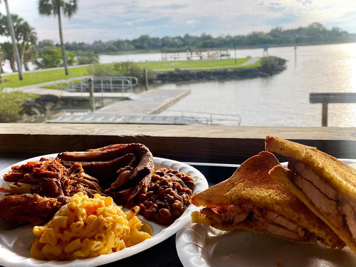 Captain's combo sampler with brisket, pulled pork, mac and cheese and smoked "baked" beans, alongside smoked turkey sandwich from Captain's BBQ in Palm Coast.