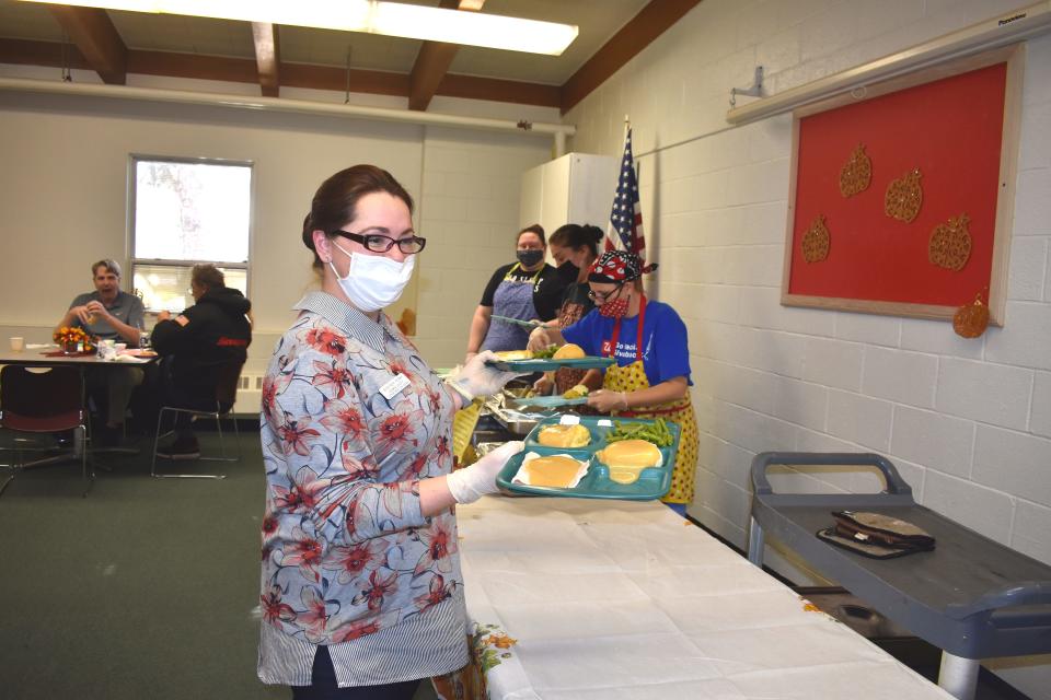 Jennifer Perry, director of the Adrian Senior Center, gets ready to serve traditional Thanksgiving dinners to hungry patrons Thursday during the senior center's annual community Thanksgiving dinner and get-together.