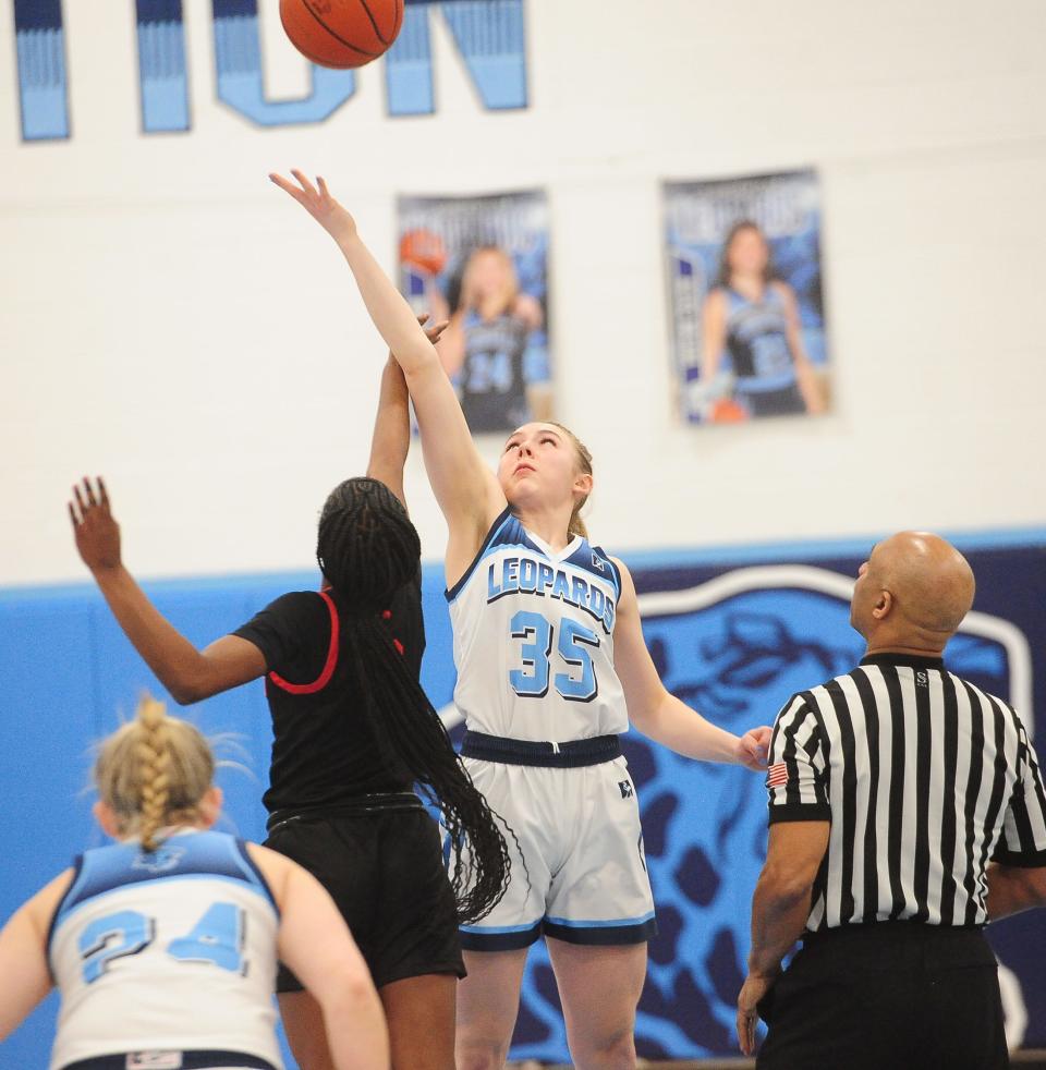 Louisville's Chay Cline battles for control of the tipoff in a Division I sectional final against Chaney, Thursday Feb. 22, 2024.