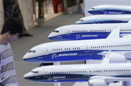 A visitor looks at a display of miniature Boeing passenger aircrafts at Aviation Expo China 2013 in Beijing in this September 25, 2013 file photo. REUTERS/Kim Kyung-Hoon/Files (