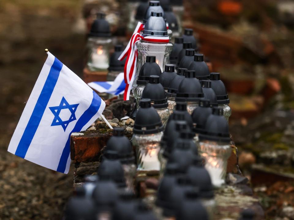 The `flag of Israel and candles are seen during the 78th Anniversary Of Auschwitz - Birkenau Liberation ceremony