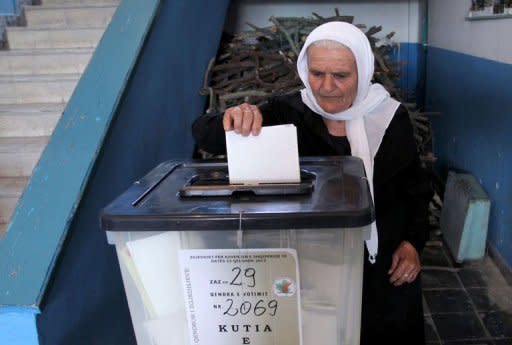 An Albanian woman casts her vote at a polling station in the village of Fushas, near Tirana, on June 23, 2013. A shootout that killed an opposition activist cast a shadow over Albania's crucial general election on Sunday, with both sides claiming victory in a vote that could determine whether one of Europe's poorest countries has a chance of joining the EU