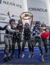 In this photo provided by SailGP, Manon Audinet, center, strategist of France SailGP Team, lifts the Spain Sail Grand Prix trophy onboard alongside her teammates as France SailGP Team celebrate winning their first ever SailGP event at the Spain Sail Grand Prix in Cadiz, Andalusia, Spain, Sunday, Sept. 25, 2022. (Ricardo Pinto/SailGP via AP)