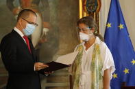 European Union Ambassador to Venezuela Isabel Brilhante Pedrosa is presented with a letter of "persona non grata" from Venezuelan Foreign Minister Jorge Arreaza at his office in Caracas, Venezuela, Wednesday, Feb. 24, 2021. The meeting was called after the EU sanctioned an additional 19 Venezuelans for "undermining democracy and the rule of law" in Venezuela and the National Assembly declared the EU ambassador "persona non grata." (AP Photo/Ariana Cubillos)