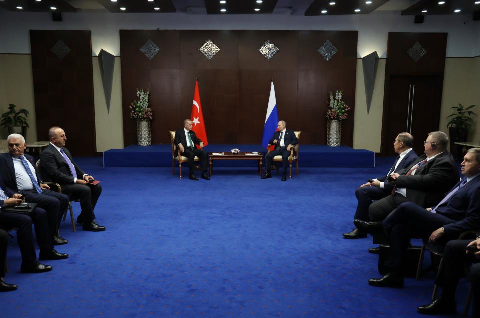 Russia's President Vladimir Putin, center right, and Turkey's President Recep Tayyip Erdogan, center left, talk to each other during their meeting on sidelines of the Conference on Interaction and Confidence Building Measures in Asia (CICA) summit, in Astana, Kazakhstan, Thursday, Oct. 13, 2022. (Vyacheslav Prokofyev, Sputnik, Kremlin Pool Photo via AP)