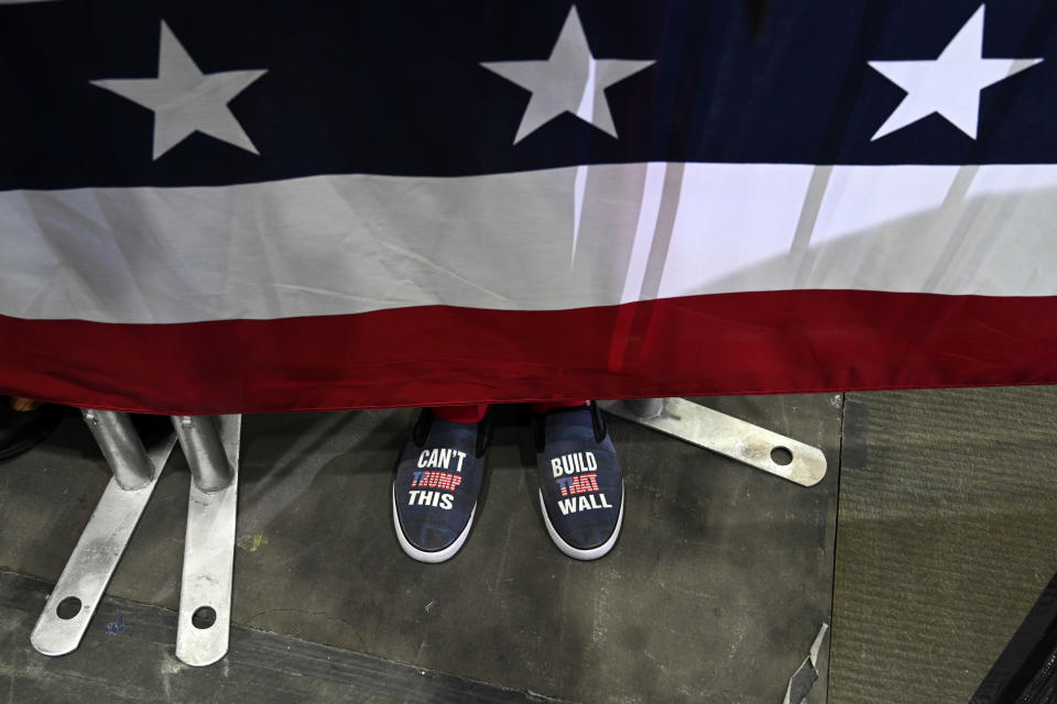 People wait for President Donald Trump to speak at a rally in Estero, Fla., Wednesday, Oct. 31, 2018. (AP Photo/Susan Walsh)