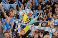 Manchester City fans celebrate after beating Manchester United during their English Premier League football match at The Etihad stadium in Manchester, north-west England on April 30, 2012. AFP PHOTO/ANDREW YATES RESTRICTED TO EDITORIAL USE. No use with unauthorized audio, video, data, fixture lists, club/league logos or “live” services. Online in-match use limited to 45 images, no video emulation. No use in betting, games or single club/league/player publications.ANDREW YATES/AFP/GettyImages