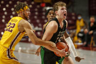 Minnesota guard Gabe Kalscheur (22) fouls North Dakota forward Mitchell Sueker (35) as guard Marcus Carr (5) helps defend in the second half of an NCAA college basketball game Friday, Dec. 4, 2020, in Minneapolis. (AP Photo/Bruce Kluckhohn)